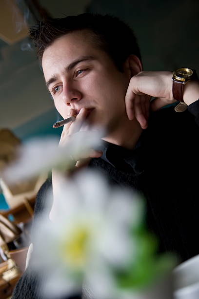 istock Young adult man smoking in a restaurant 105870076
