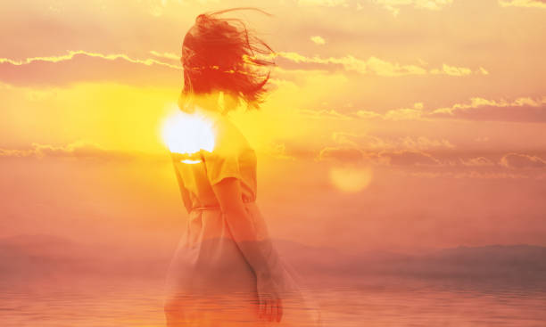 istock Woman and sunset sky. 1058704050