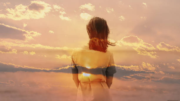 istock Woman and sunset sky. 1058704084