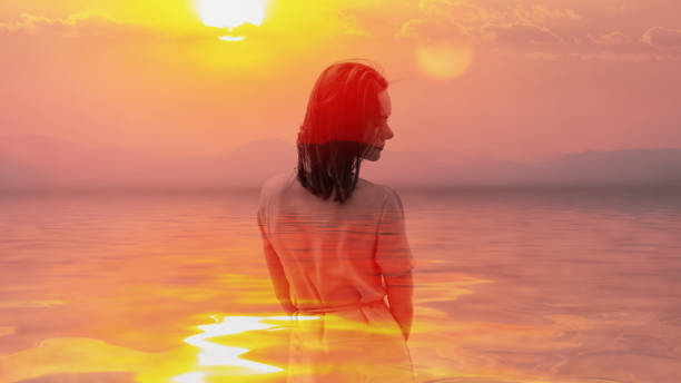 istock Woman and sunset sky. 1058704168