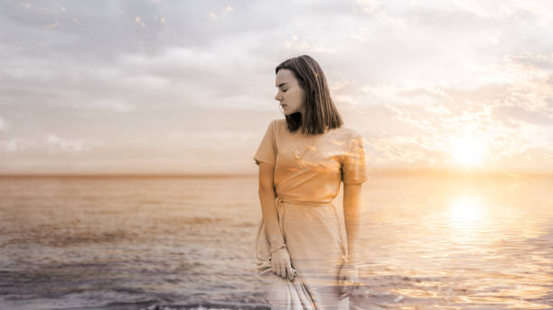istock Woman and sunset sky. 1058704482