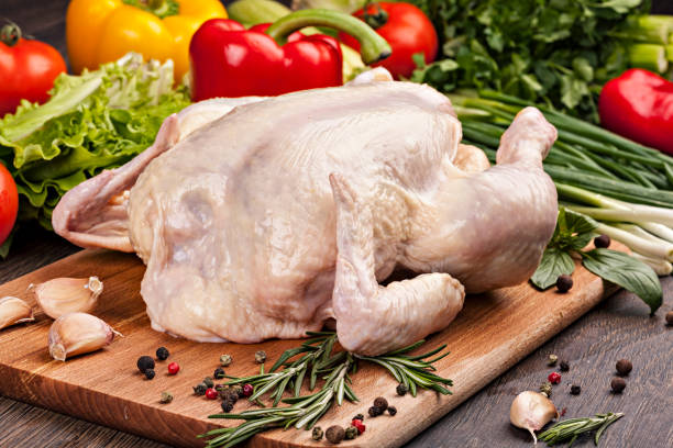 istock Fresh raw chicken meat with vegetables, spices and herbs ready for baking. 1058704524