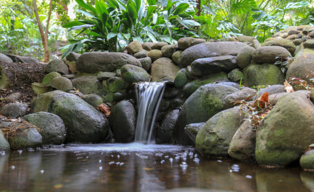 istock Small waterfall flowing on rock in woods 1058704988