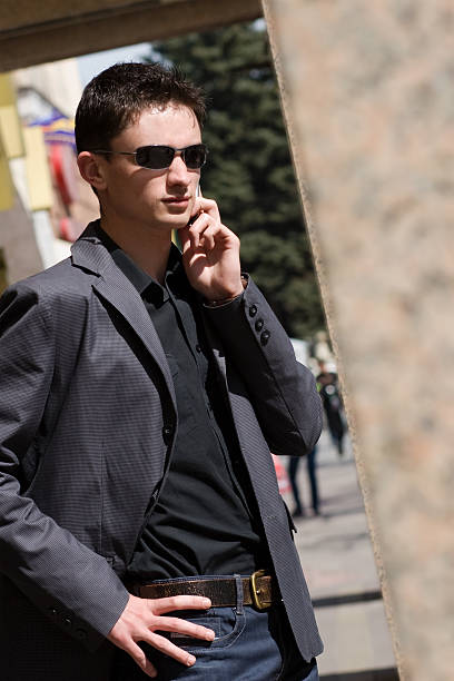 istock Businessman in sunglasses talks on mobile phone 105870728