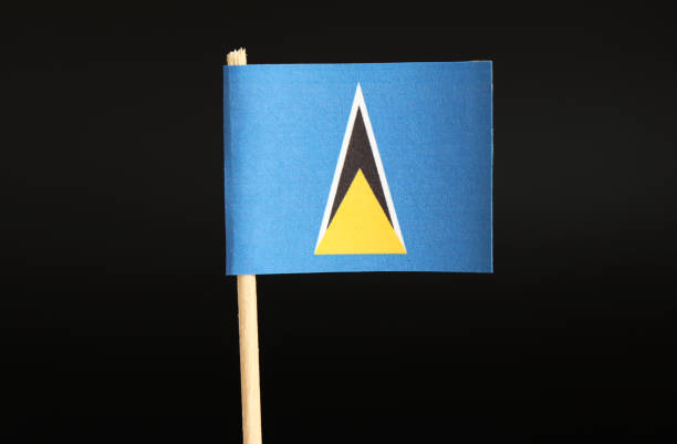 A official Flag of Saint Lucia on toothpick and on black background. The state located in caribbean sea on north america continent. A official Flag of Saint Lucia on toothpick and on black background. The state located in caribbean sea on north america continent. Official national flag. isosceles triangle stock pictures, royalty-free photos & images