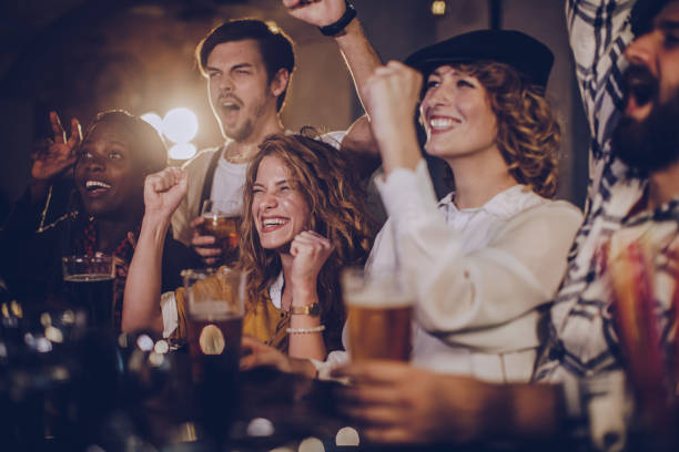 istock Friends in bar watching match 1058709478