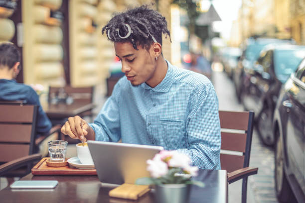 istock Young influencer is blogging from a sidewalk caffee 1058710672