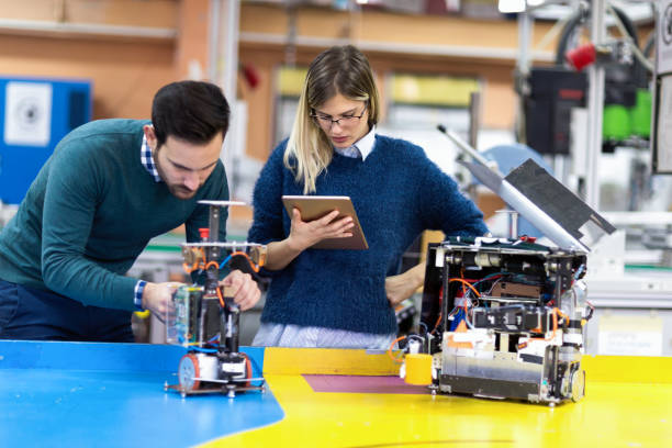 istock Young attractive students of mechatronics working on project 1058715692