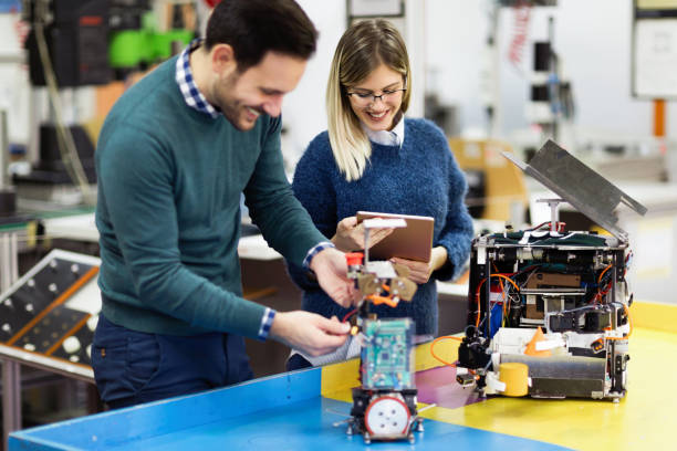 istock Young attractive students of mechatronics working on project 1058715694