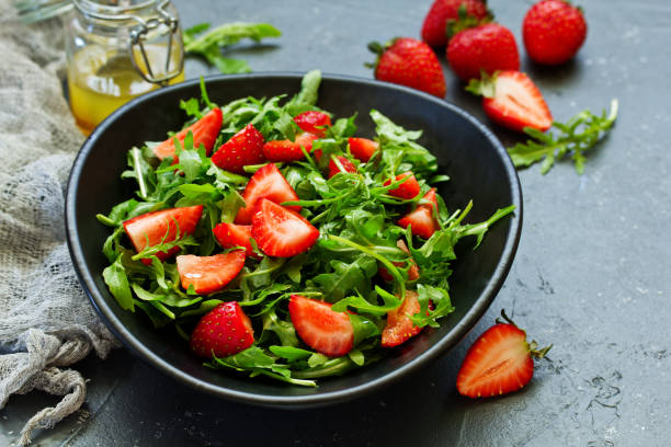 istock Fresh salad with arugula, strawberries and almonds. Selective focus. 1058715858