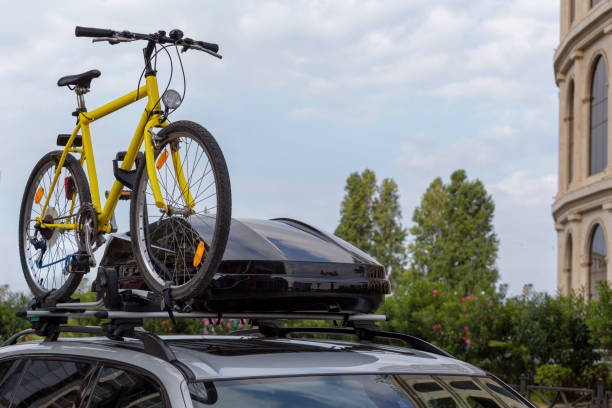 Transportation of bicycles on the roof of the car. Concept: a car trip with a bike stock photo