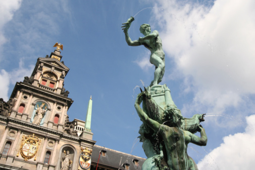 Famous statue on Antwerp market place, with City Hall in the background