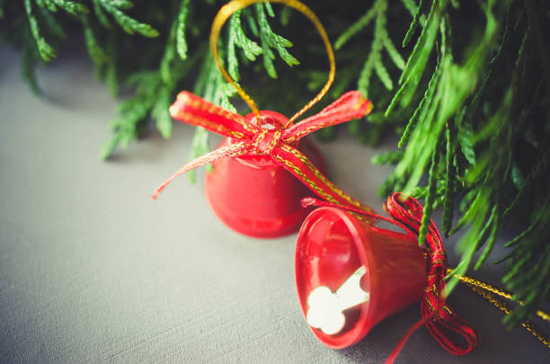 istock Christmas background with xmas fir branches and red bells. 1058719924