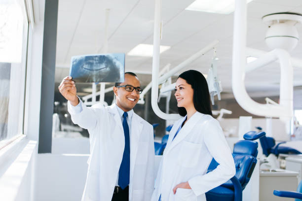istock Happy latin doctors looking at x-ray 1058719960