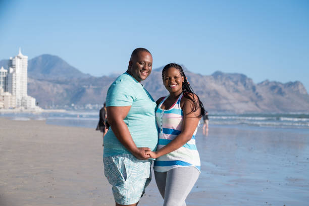 istock Affectionate African couple on the beach 1058720014
