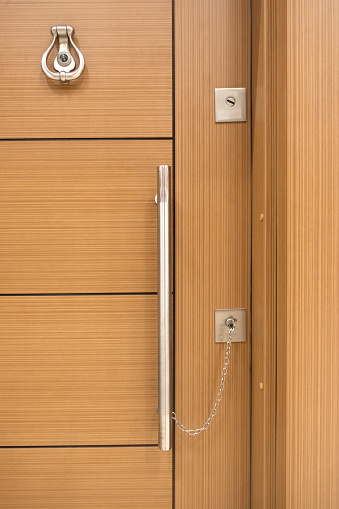 Door knocker with peep hole, handle and door knocker on wooden door. security Measure