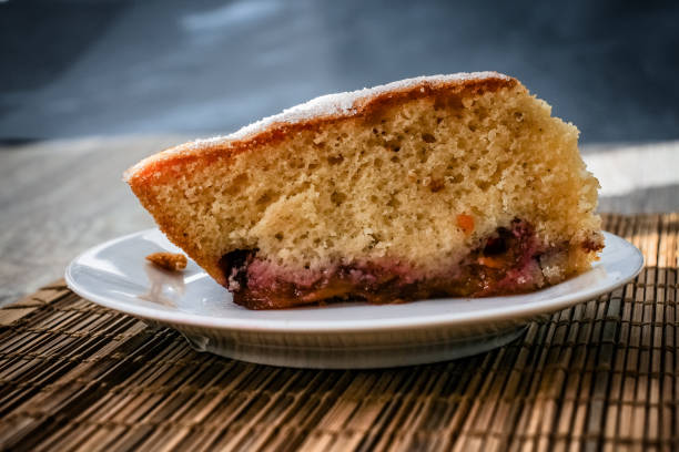istock Large shot of sponge cake plum pie. 1058721798