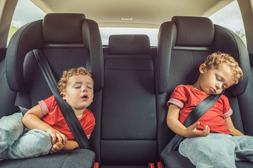 Brothers sleeping in car
