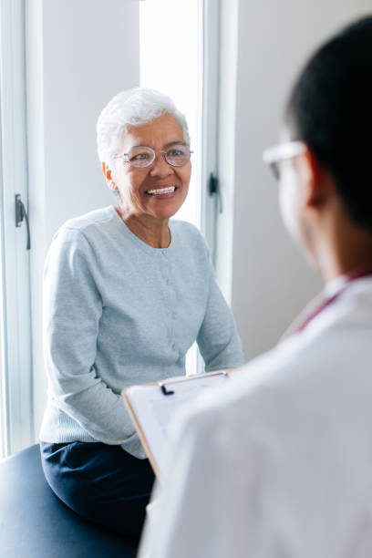 istock Senior female patient consulting at doctor's 1058722916