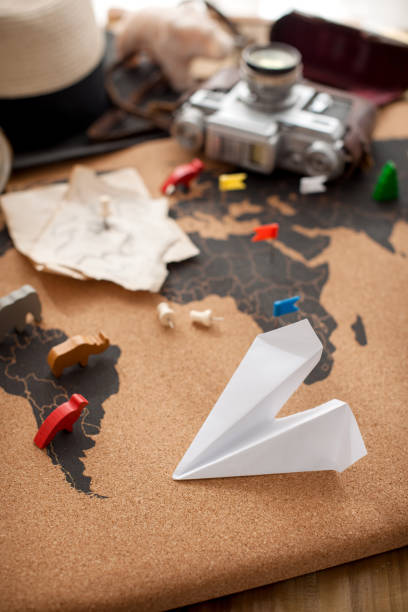 istock Old map, camera, hat and sunlight from the window on the table. Retro style photo. Plans for traveling. Copy space 1058725728