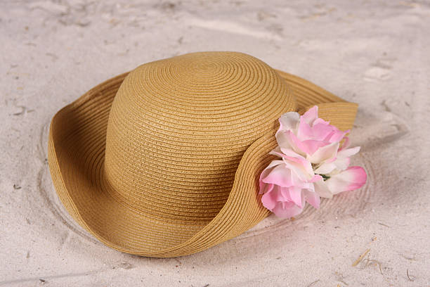 istock Woman's beach hat laying in the sand 105872773