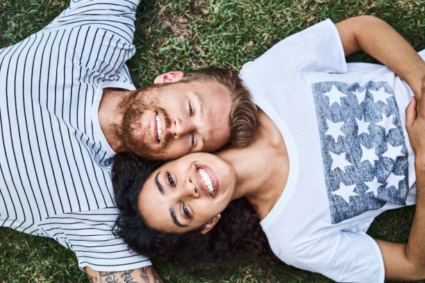 istock Directly above view of couple relaxing on grass 1058728198