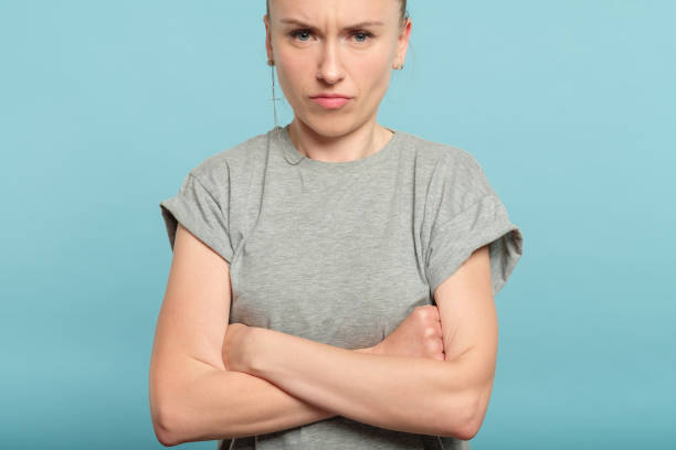 istock grumpy angry tough woman crossed arms emotional 1058729766