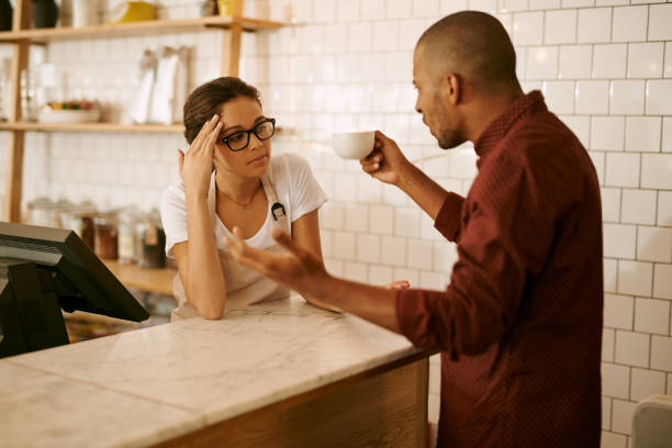 How can you call this coffee? Shot of a young woman serving a difficult customer in a coffee shop rudeness stock pictures, royalty-free photos & images