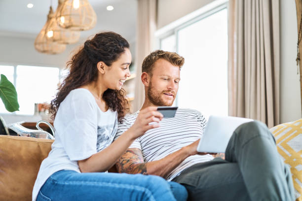 istock Couple shopping online with digital tablet at home 1058730264