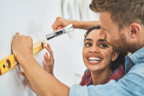 istock Happy young woman looking at boyfriend using tools 1058730500