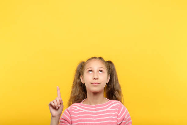 istock look above girl point index finger virtual object 1058730794