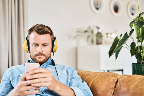 istock Handsome young man relaxing while listening music 1058731240