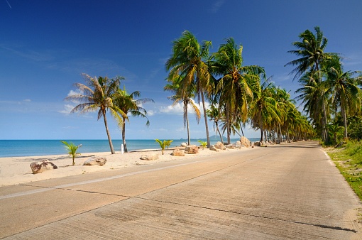 Scenic concrete road along paradise beach