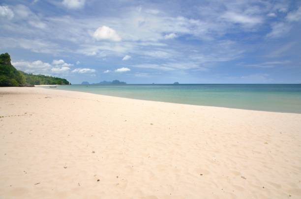 istock Paradise Thung San beach with white sand and rocky limestone cliff 1058732542
