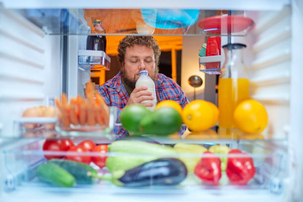 istock Hungry man taking food from fridge. 1058733030