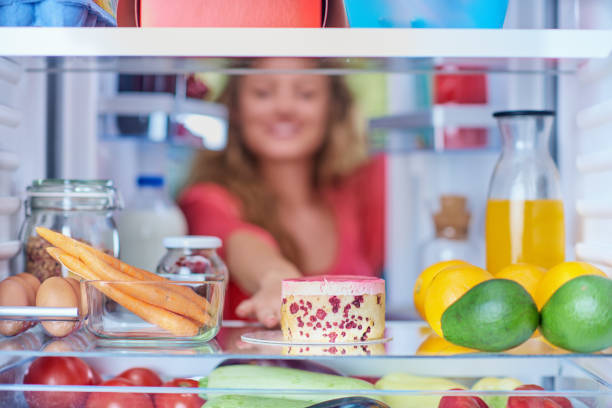istock Woman taking gateau form fridge. 1058735154