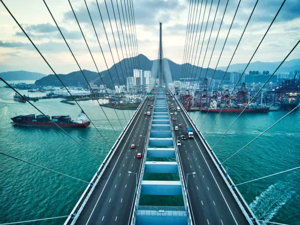 Photo of Bridge in Hong Kong and Container Cargo freight ship