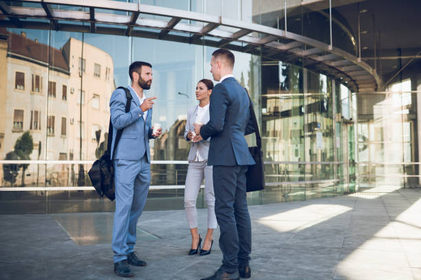 istock Three business colleagues having discussion while standing outdoors 1058740910