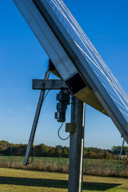 istock Solar system, solar power plant with trackable elements in sunshine. Side view with servomotor, Close-up 1058741214