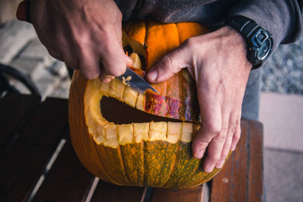 istock Carving out a pumpkin to prepare halloween lantern 1058744028
