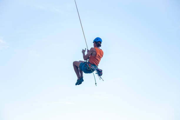 istock Man jumping with rope from mountain 1058744702
