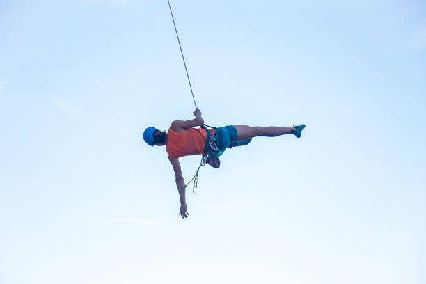 istock Man jumping with rope from mountain 1058744722