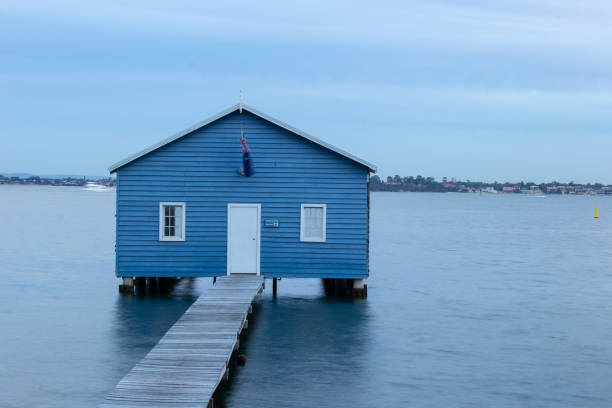 istock Blue Boat House In Perth at cloudy sunset 1058744928