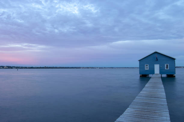 istock Blue Boat House In Perth at cloudy sunset 1058745064