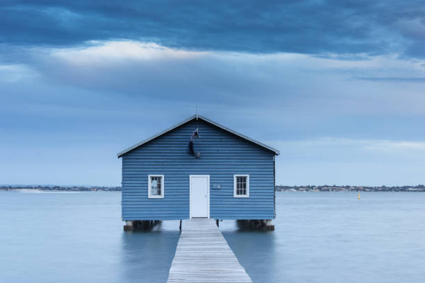 istock Blue Boat House In Perth at cloudy sunset 1058746138