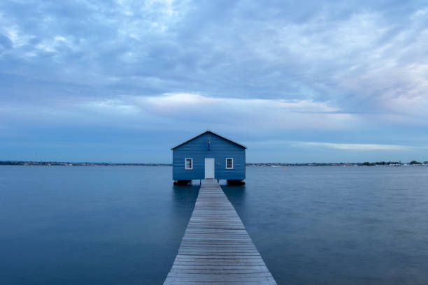 istock Blue Boat House In Perth at cloudy sunset 1058746306