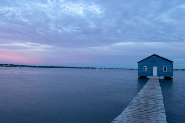 istock Blue Boat House In Perth at cloudy sunset 1058746380