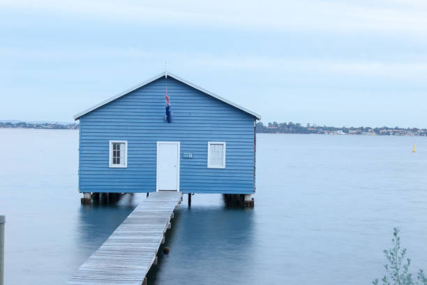 istock Blue Boat House In Perth at cloudy sunset 1058746486