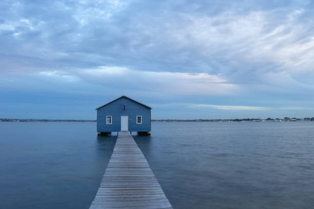 istock Blue Boat House In Perth at cloudy sunset 1058746570
