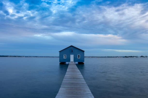 istock Blue Boat House In Perth at cloudy sunset 1058746572